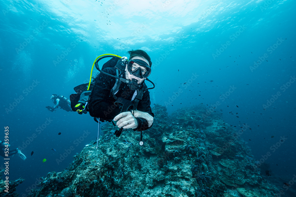 Diver exploring the tropical waters at the Andaman Sea in Thailand Diver exploring the tropical waters at the Andaman Sea in Thailand