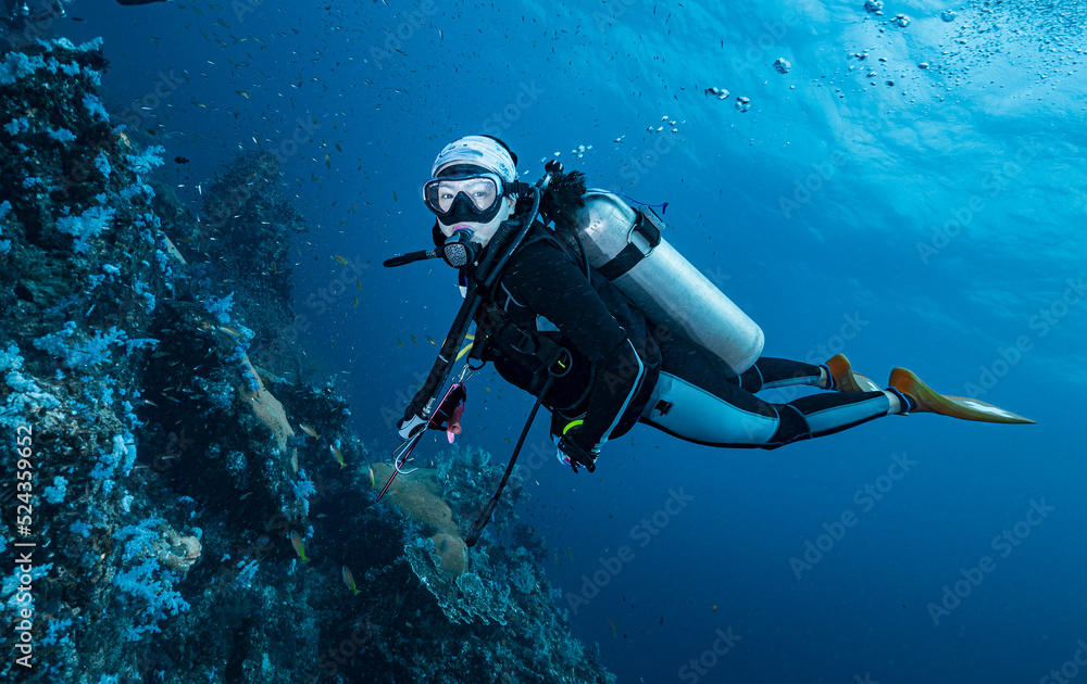 Diver exploring the tropical waters at the Andaman Sea in Thailand Diver exploring the tropical waters at the Andaman Sea in Thailand