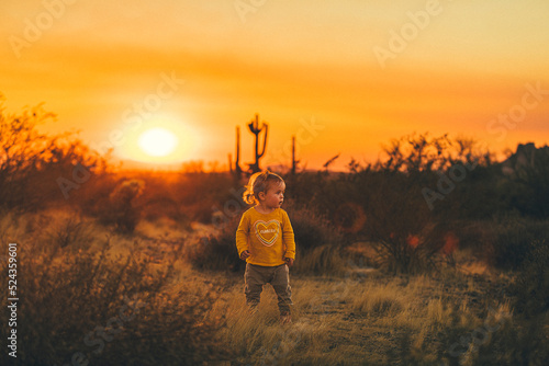 A kid is walking between cactuses in Lost Dutchman State Park