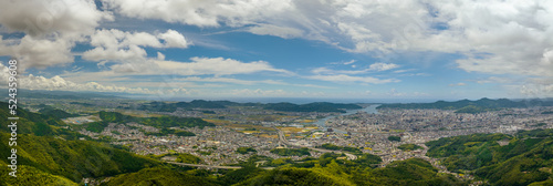 Panoramic aerial view of Kochi, a small city between mountains and sea on sunny day