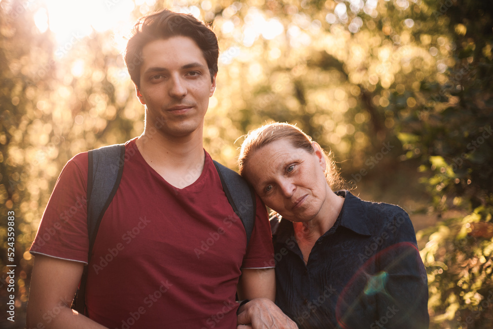 Portrait of thoughtful mother and son standing in park during summer Portrait of thoughtful mother and son standing in park during summer