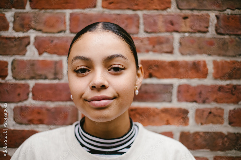 Portrait of classy latina woman against a brick wall Portrait of classy latina woman against a brick wall
