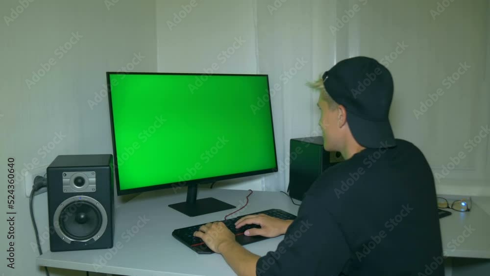 Blogger or streamer welcomes his viewers. Chroma key. Video with a chroma key on the screen to insert any video with friendly human reaction to it. Blogger or streamer welcomes his viewers. Chroma key. Video with a chroma key on the screen to insert any video with friendly human reaction to it.