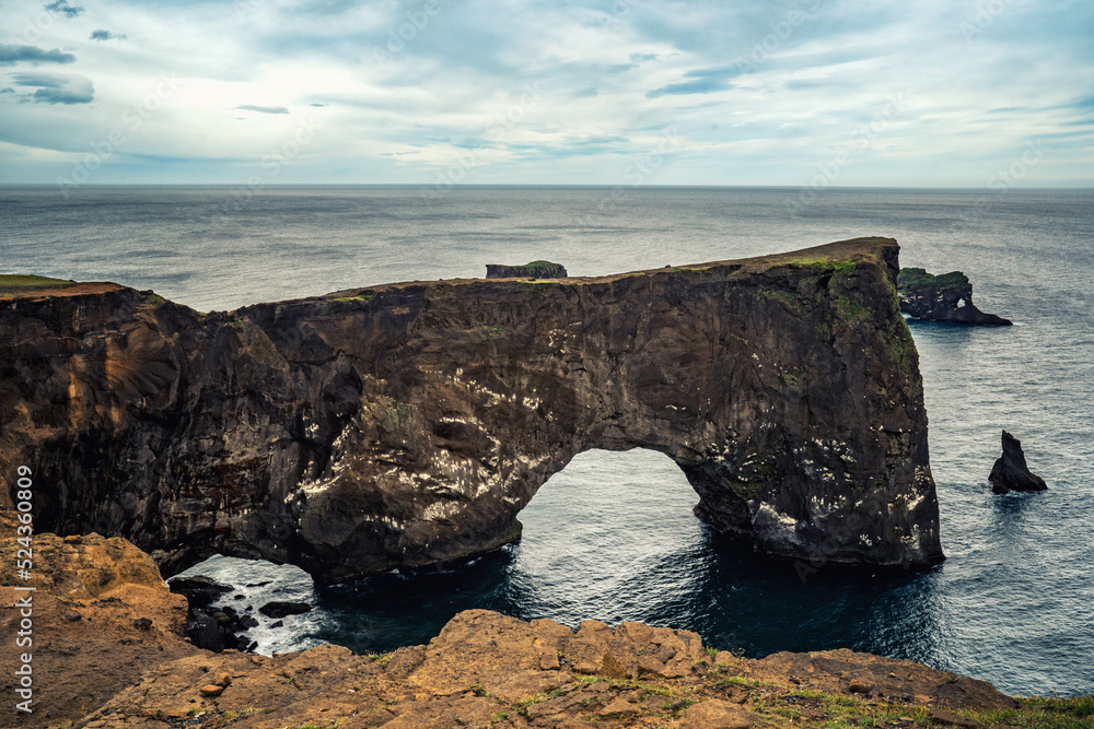 Vik, Iceland - July 3, 2022 landscape view of the famous Dyrhólaey Arch, a large arch of volcanic rock along the south coast of Iceland.