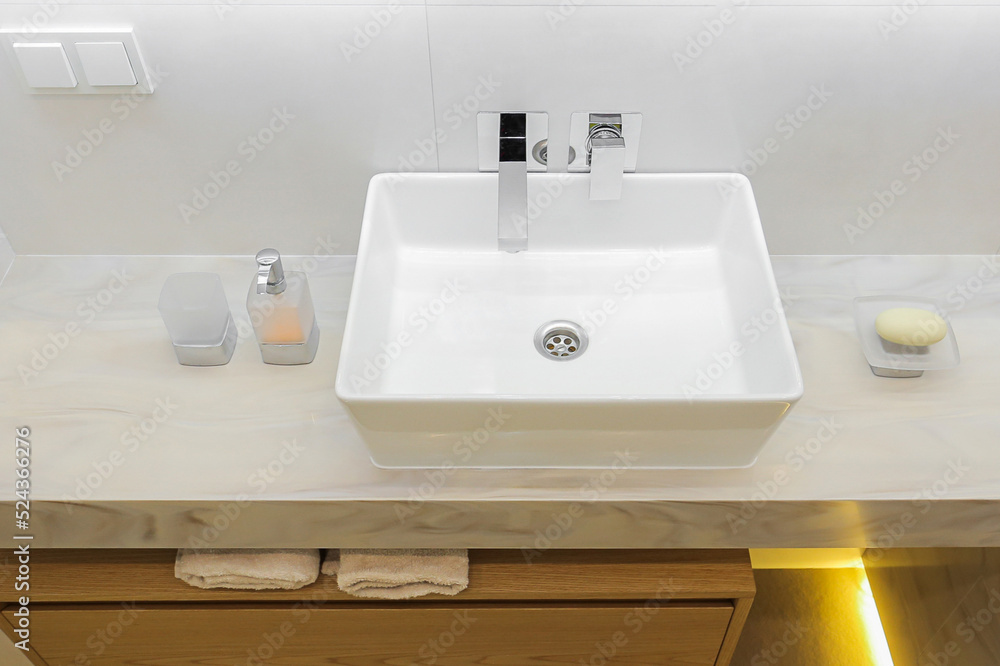 Fototapeta premium Modern white bathroom sink with faucet