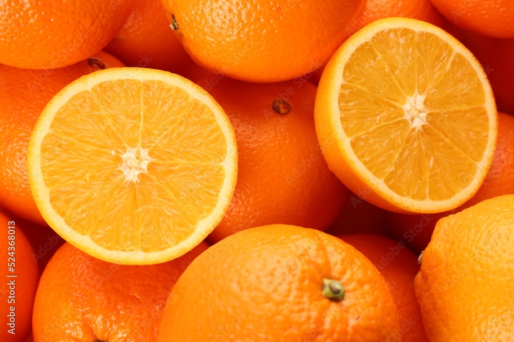 Cut and whole fresh ripe oranges as background, top view Cut and whole fresh ripe oranges as background, top view
