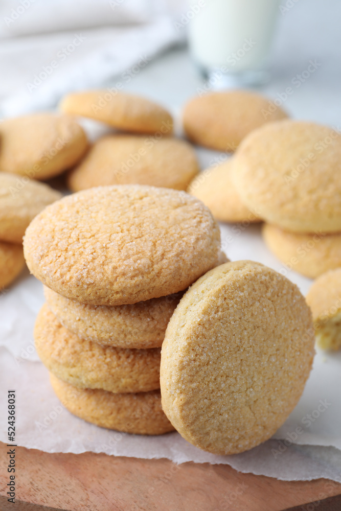 Many tasty sugar cookies on wooden board, closeup Many tasty sugar cookies on wooden board, closeup