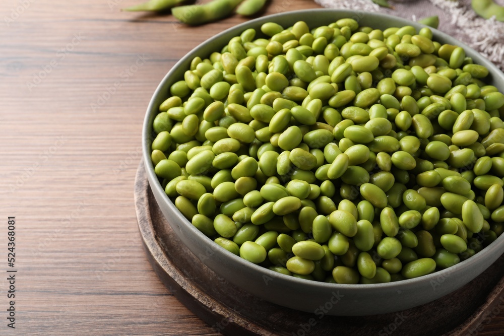 Bowl of delicious edamame beans on wooden table, closeup Bowl of delicious edamame beans on wooden table, closeup