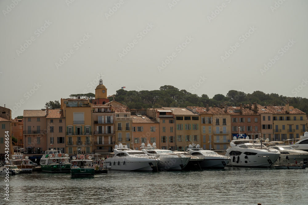Fototapeta premium Colorful houses and yachts in Port of Saint Tropez, village on Mediterranean sea with yacht harbour, Provence, France