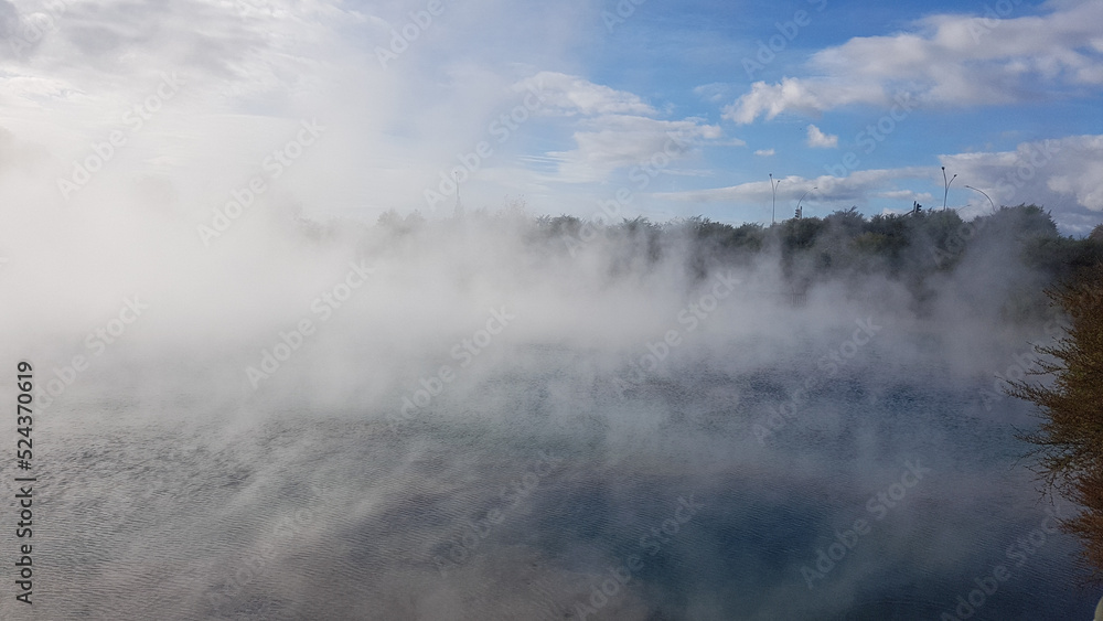 Steam over a thermal lake in Rotorua park, New Zealand Steam over a thermal lake in Rotorua park, New Zealand