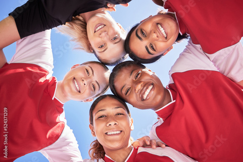 Female soccer team huddle bonding, smiling or motivated in circle with heads in middle. Below portrait of fit, active and diverse group of football girls, friends or athletes at sports, match or game