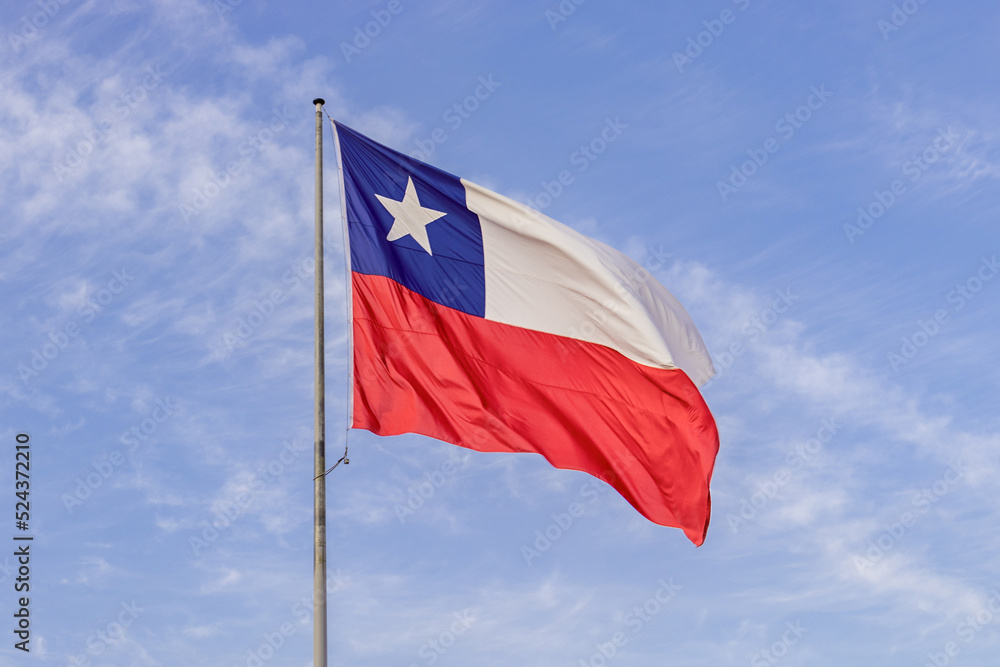 Chilean flag raised in good condition with blue sky in the background, concept: chilean national holidays. Chilean flag raised in good condition with blue sky in the background, concept: chilean national holidays.