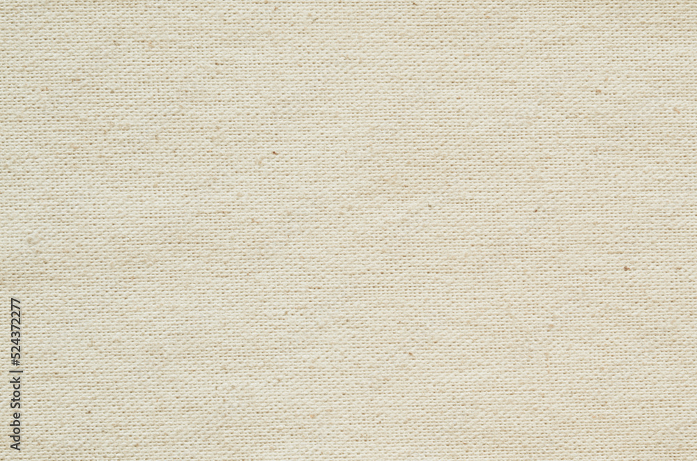 Fototapeta premium Close-up texture of natural weave cloth. Champagne gold fabric background. Natural linen or cotton textile material.