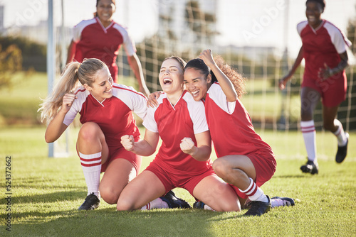 Fototapeta Naklejka Na Ścianę i Meble -  Celebrate, winning and success female football players with fist pump and hurray expression. Soccer team, girls or friends on a field cheering with victory sign, celebrating win in a sports match