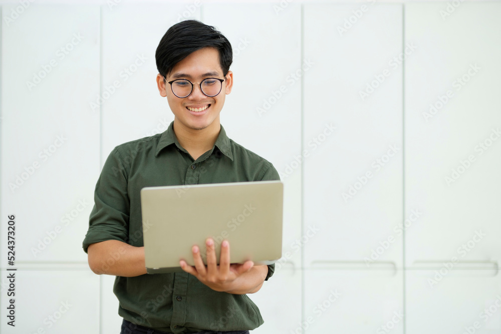 Young asian business man or student working online on computer laptop. Young asian business man or student working online on computer laptop.