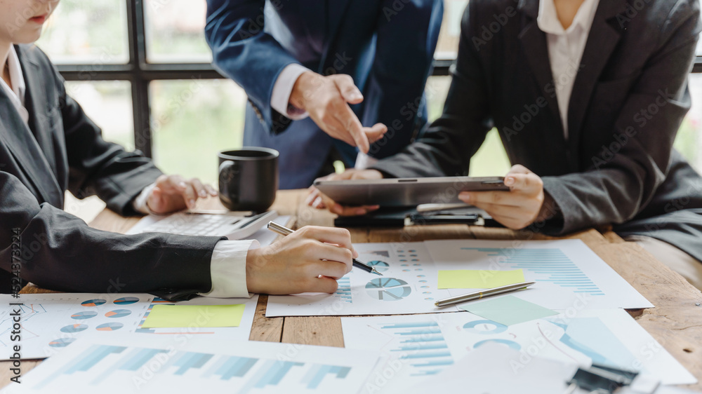Close-up of businessman and woman explaining a financial plan to colleagues at meeting. Close-up of businessman and woman explaining a financial plan to colleagues at meeting.