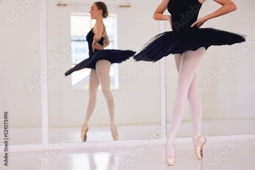 Ballet art performance dancer dancing, training and doing a balance on her feet with pointe shoes in an arts studio hall. Classical, fitness and theatre ballerina on the floor on her tip toes on foot