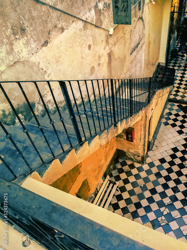 View in perspective from a high angle view of an old stairs in a antique residential house