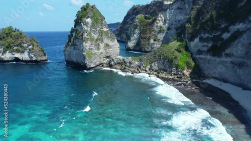 Aerial video of drone flying forward towards gap in the cliff on Nusa Penida island
