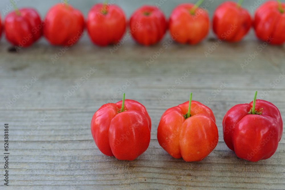 Fresh Acerola cherry, Barbados cherry, on wood background, High vitamin C and antioxidant fruits. Fresh Acerola cherry, Barbados cherry, on wood background, High vitamin C and antioxidant fruits.