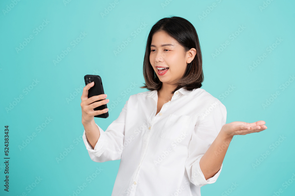 Beautiful Asian woman feels shocked with the phone Beautiful Asian woman feels shocked with the phone