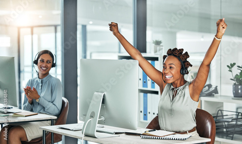 Canvastavla Call centre, cheerful and agent celebrating with arms up at her office desk