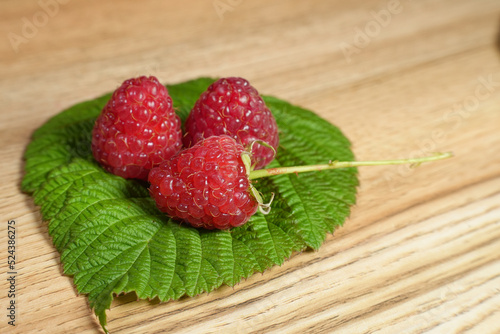 Ripe red raspberry is on the table