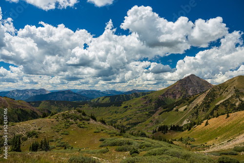 Alpine tundra hills and mountain peaks with big clouds