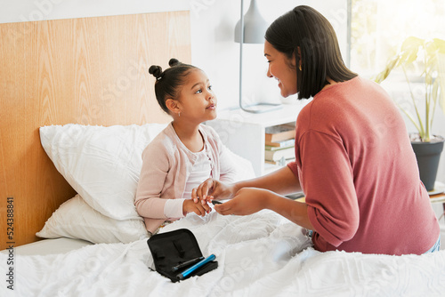 Care, health and diabetic girl talking and bonding with mother, learning to balance her illness. Loving parent caring for her child, teaching her diabetes awareness, doing routine insulin treatment photo