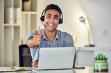 Thumbs up by call center, looking pleased and showing support with hand gesture while working on a laptop in an office alone at work. Portrait of an excited customer service agent expressing thanks