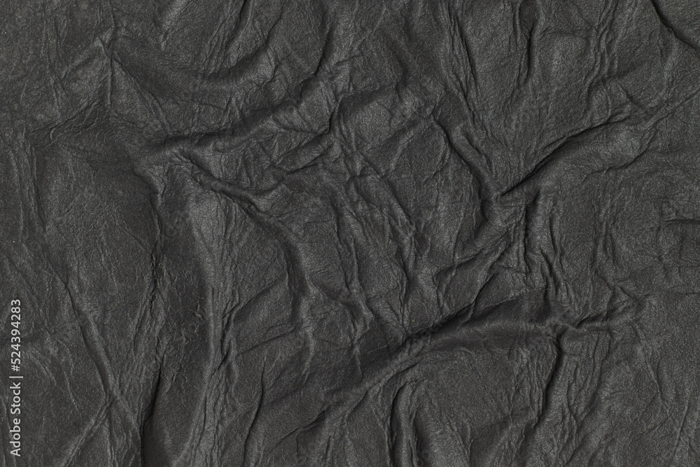 Fototapeta premium Crumpled wet black paper. Texture background.