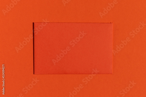 Red greeting card on red background. Minimalistic flat lay.