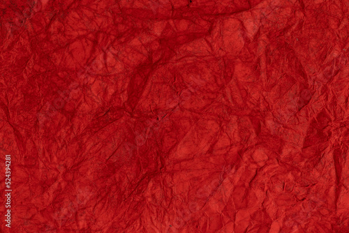 Crumpled wet red paper. Texture background.
