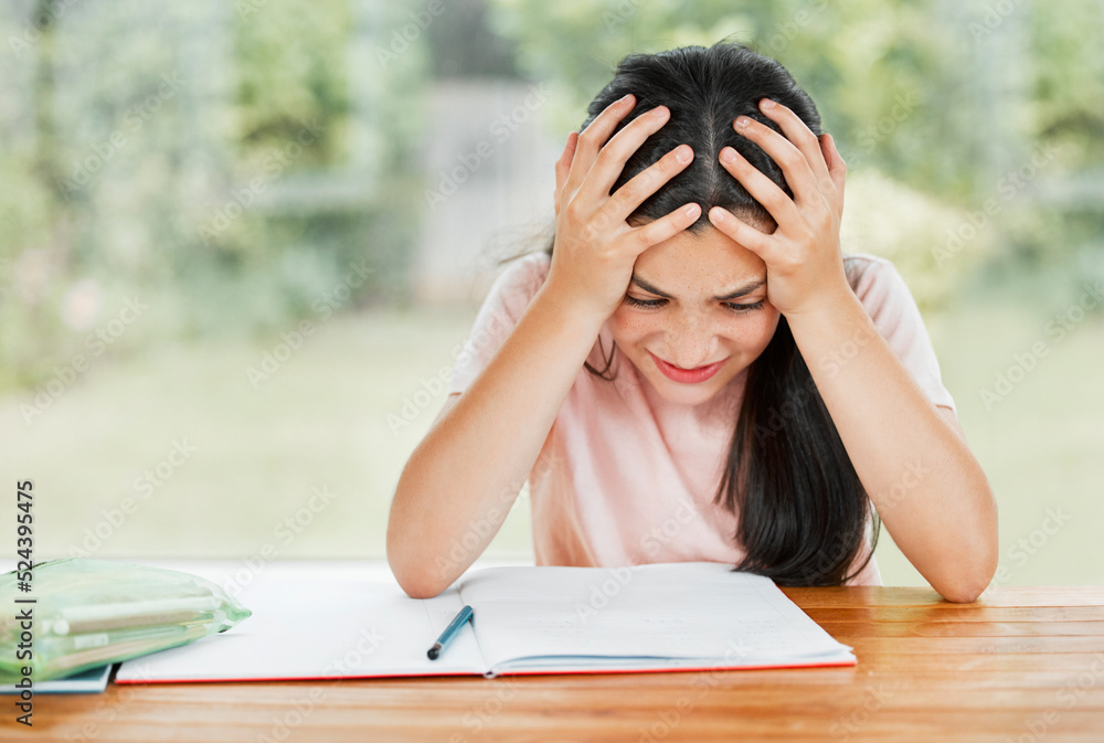 Stress, anxiety and overwhelmed with a little girl struggling with her studies, education and learning at home. Confused, frustrated and tired student having trouble with homework and study material Stress, anxiety and overwhelmed with a little girl struggling with her studies, education and learning at home. Confused, frustrated and tired student having trouble with homework and study material