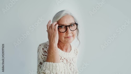 Elderly woman in casual clothes posing on a white background