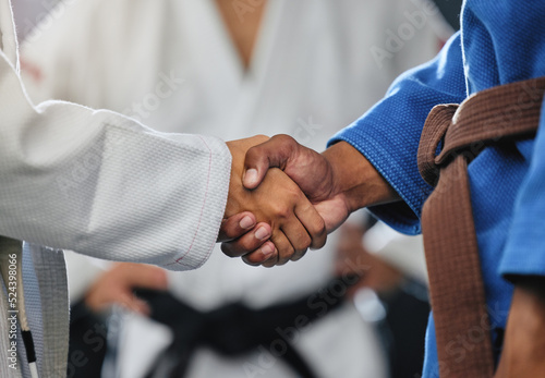 . Handshake, respect and discipline with mma, karate and fight students shaking hands before a match or combat sport in a training gym or dojo. Training, exercise and workout in self defense class.