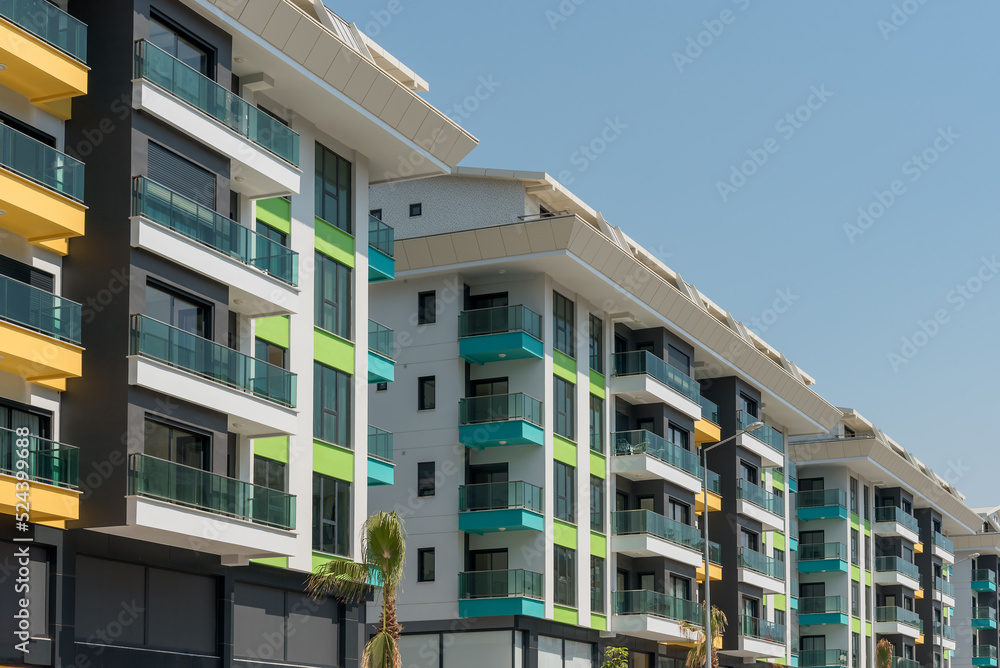 Modern freshly built apartment buildings on a sunny day with blue sky. Modern freshly built apartment buildings on a sunny day with blue sky.