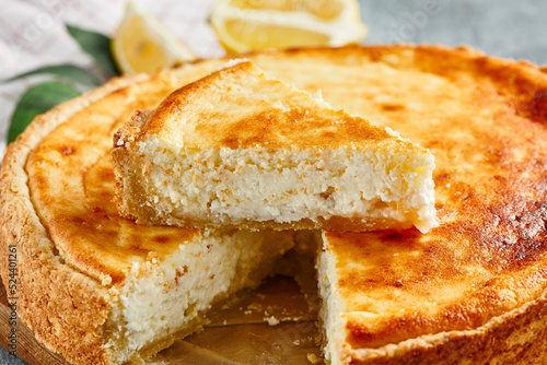 Sweet bakery - cottage cheese pie on gray stone background. Baked cheesecake in rustic style on stone table. Aesthetic composition with cottage pie. Cottage cheese  tart.