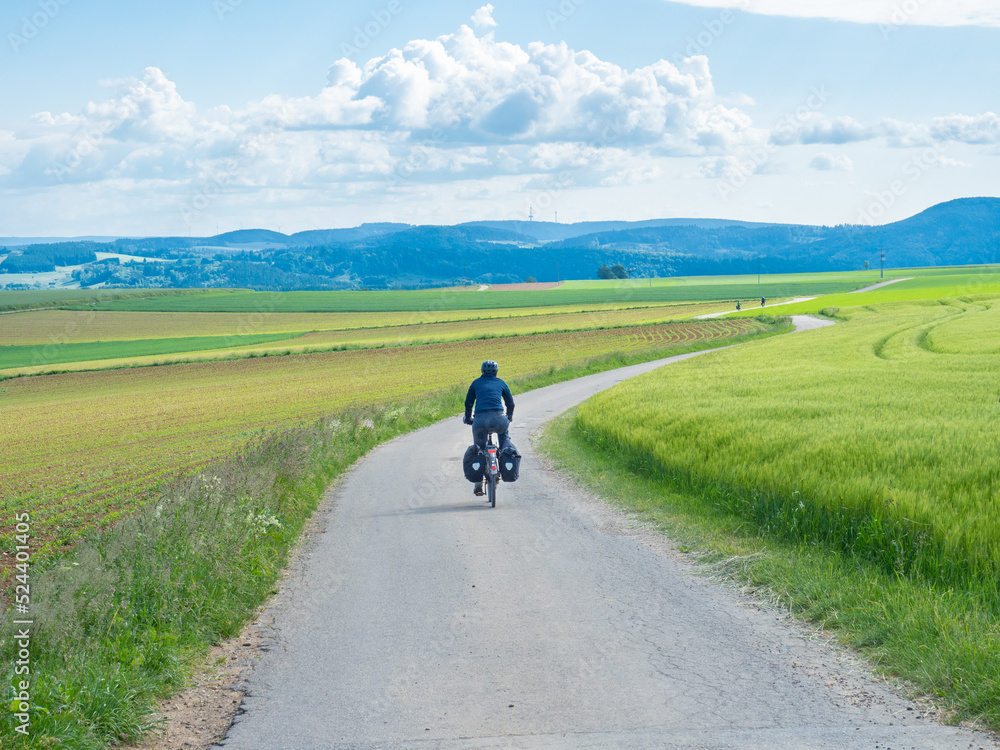 Black forest, Germany - May 29th 2022: A cyclist in the open landscape of Schwarzwald. Black forest, Germany - May 29th 2022: A cyclist in the open landscape of Schwarzwald.