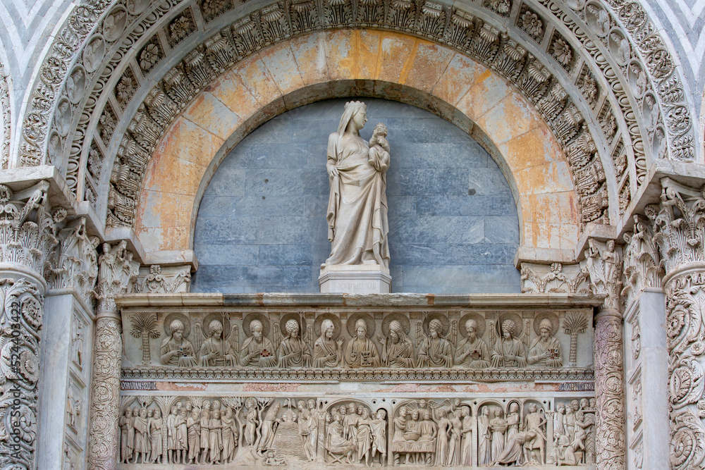 Decorative portal above the main entrance to Pisa Baptistery of St. John on Piazza del Duomo, Pisa, Italy.