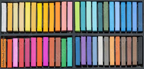 A box of pastel chalks - many different, intense colours in a pastel chalk box, ready to create a work of art - beautiful colours to create a work of art 