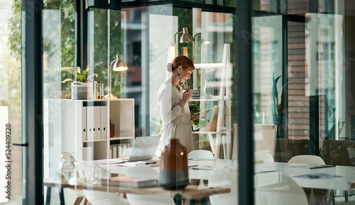 A modern office, building interior and a businesswoman doing online research on a tablet or looking at files. Female inside her corporate workplace architecture indoors preparing for a presentation.