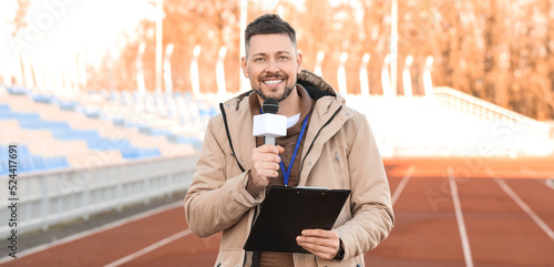 Male reporter with micropho...