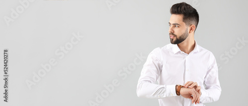 Handsome man with healthy hair on light background with space for text