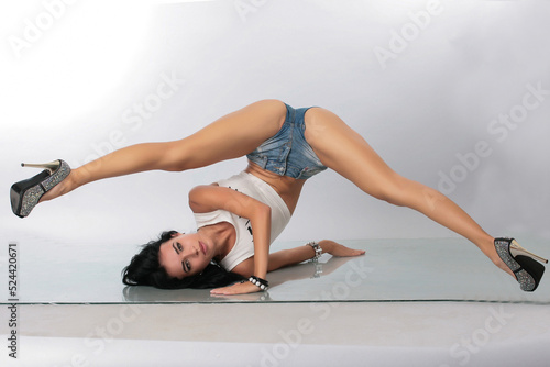 Tableau sur toile a pretty girl brunette stretching instructor, go-go, trainer, danser, posing in
