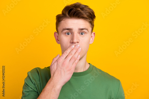 Canvas Print Young man isolated on bright background covering mouth with hand concept of erro