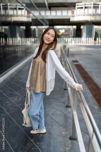 Lifestyle portrait photo of a beautiful young asian lady relax and posing around the city after a long pandemic lockdown © asean studio