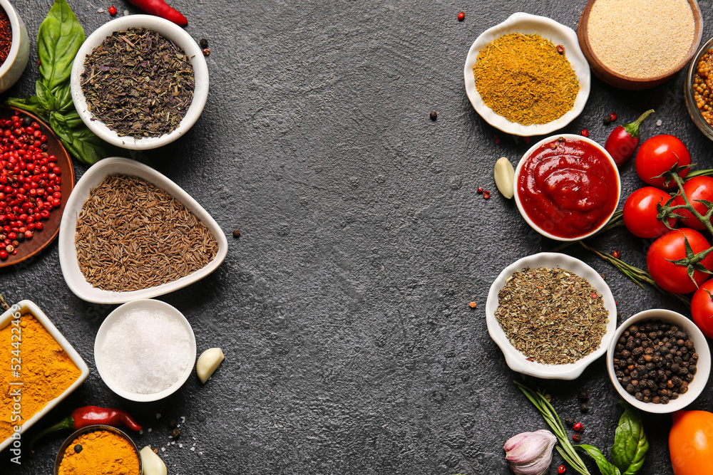 Composition with fresh aromatic spices on dark background