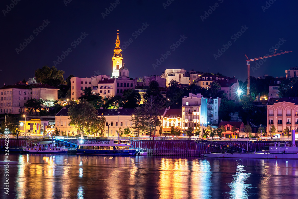 View of the historical city center and the Sava river in Belgrade, capital of Serbia at night. Night lights and water in long exposure