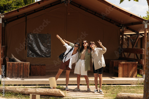 Funny young caucasian women posing for camera spending leisure time outside city in summer. Brunettes wear casual clothes. Lifestyle, different emotions, leisure concept.